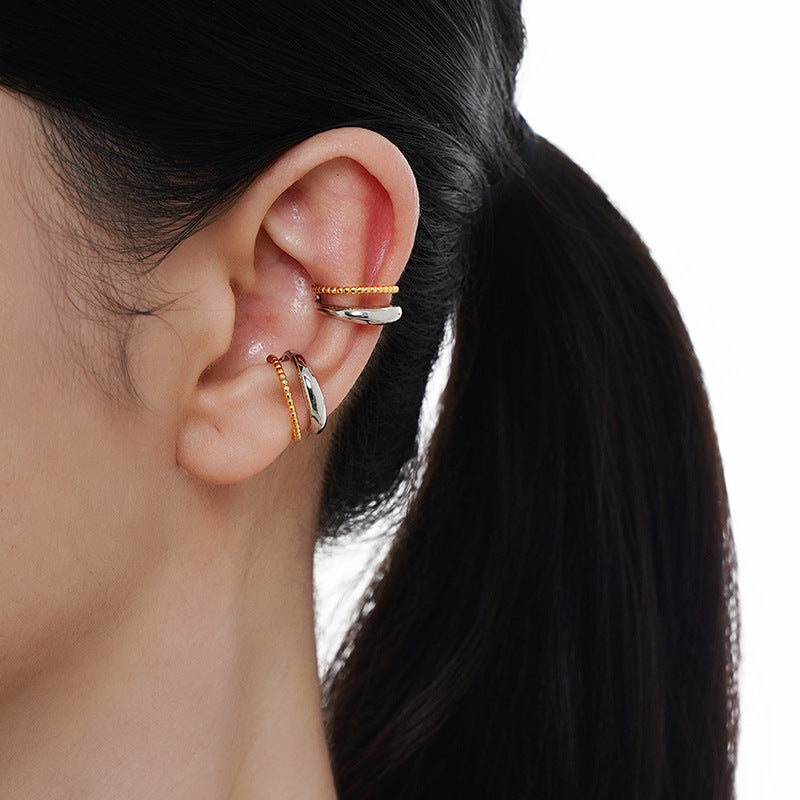 Brynja - Stilfull earcuff med gulddetaljer
