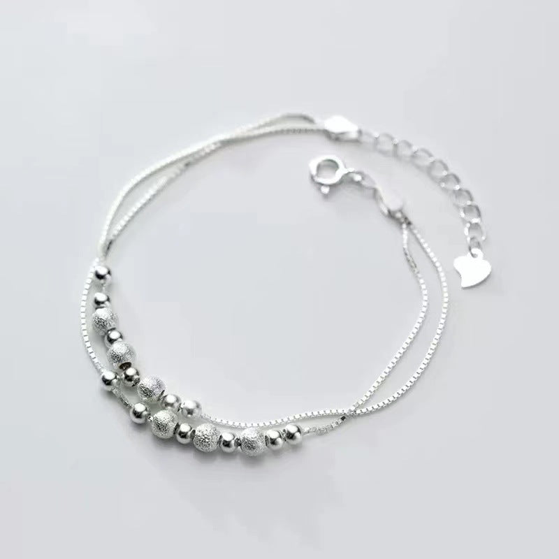 Lizzie - Armband med dubbla kedjor och kulor i olika storlekar