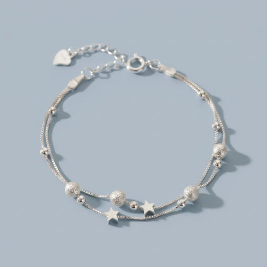 Nova - Armband med dubbla kedjor och kosmiskt motiv
